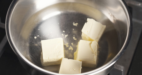 melting butter in pot close up photo