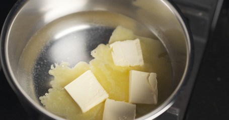 melting butter in pot close up photo