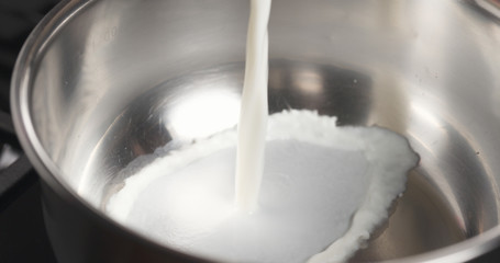 shot of pouring milk into saucepan