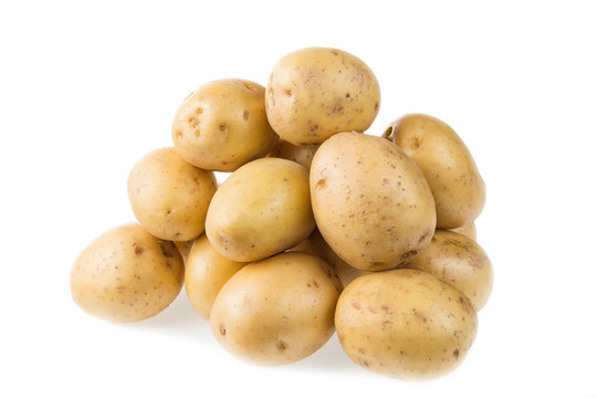 Heap of fresh young potatoes isolated on white background close up.