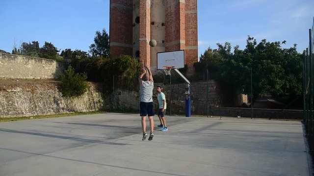 Three point shot in a playground. Slow motion effect