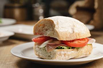 ciabatta sandwich with speck, mozzarella and vegetables