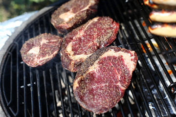 Closeup of a beef steak on the grill. Shallow depth of field