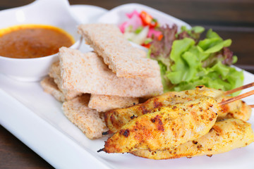Chicken Satay ,Sate Ayam with Peanut Sauce and bread , Asian skewers famous food in Malaysia Indonesia and Thailand