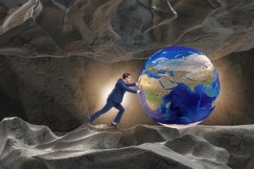 Businessman pushing the world in challenge concept