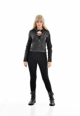 full length portrait of blonde girl wearing black leather outfit, standing pose on white background.