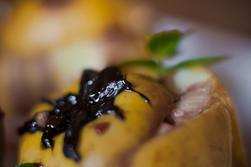 Baked apples with cottage cheese, chocolate, nuts, mint. Apples on a white plate