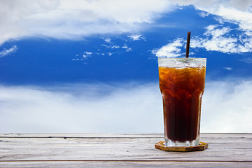 Ice coffee,americano,lemon tea,cola on wood table with blue sky and clouds nature background. Copy space.