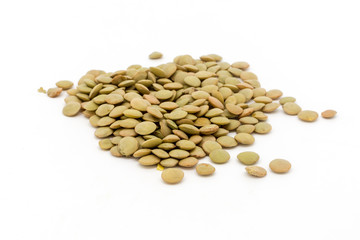 Dried green lentils against a white background
