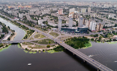 Residential district in a large metropolis with road junctions and houses near Dnepr river in Kiev, Ukraine. Aerial view. From above.