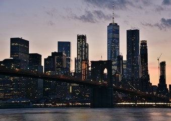 The Brooklyn Bridge and skyline of downtown Manhattan from Brooklyn at sunset. 