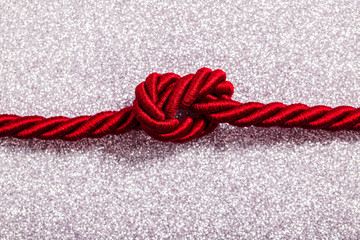 Red Rope in a knot on Silver