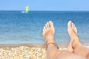 Vacation holidays. Woman feet closeup of girl relaxing on beach enjoying sun on sunny summer day.