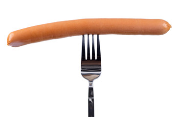 Tasty frankfurter sausage on a fork isolated