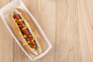 Hot dog with ketchup and mustard, taken with copy space