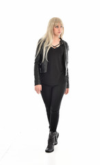 Fototapeta premium full length portrait of blonde girl wearing black leather outfit, standing pose on white background.