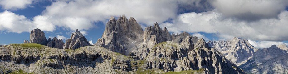 panorama with clouds and blue sky above rocks in Italy