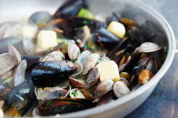 Clams and mussels on hot pan, toned