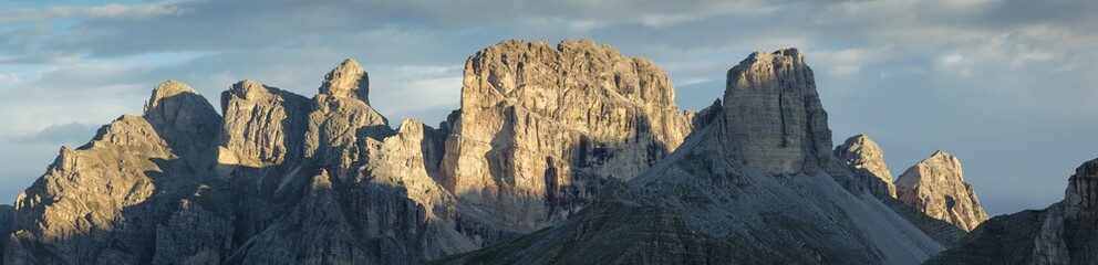 sun lights in panorama of morning mountains in Italy