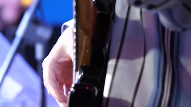 Guitar playing. Guitarist. Man hand and six-string electrical guitar. Close-up of guitarist with guitar