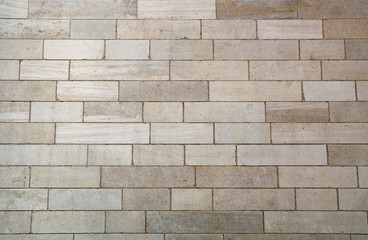 Wall of white travertine adarce stone bricks