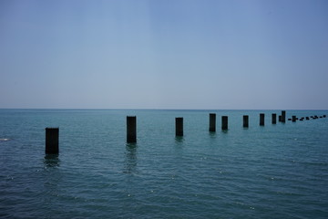 support the old ruined pier in the calm blue sea