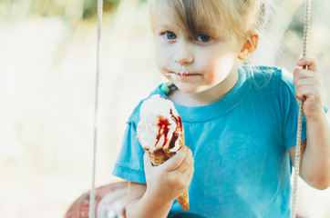 Beautiful girl five years eating ice cream in nature