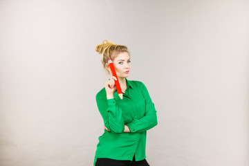 Woman confused thinking, big pencil in hand