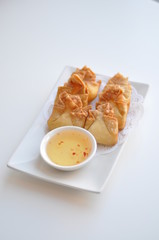 Crab Rangoon. Cream cheese, crabmeat, celery wrapped in thin crape and fried. Served with light sweet & sour sauce
