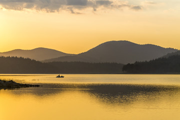 The sunset, the boat, the fisherman