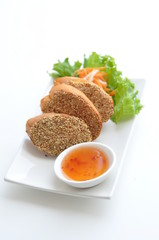 Shrimp Toast. Shrimp paste spread on French bread, deep - fried and served with homemade sauce.