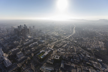 Hazy summer afternoon aerial view of urban downtown Los Angeles streets and towers. 