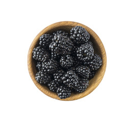 Blackberry on white background. Blackberries on a wooden bowl. Top view.