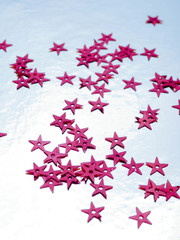 red stars confetti flying ower white background