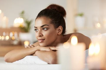 Poster Portrait of beautiful african girl resting relaxing in spa salon. © Cookie Studio