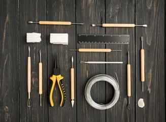 Craftsman workplace, ready for sculpturing from polymer clay. Vintage working table with molding...