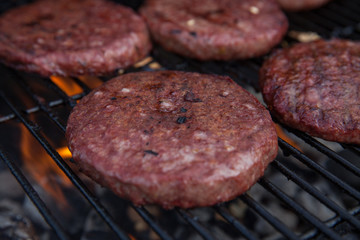 Beef or pork meat barbecue burgers for hamburger prepared grilled on bbq fire flame grill