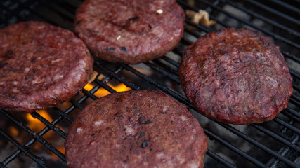 Beef or pork meat barbecue burgers for hamburger prepared grilled on bbq fire flame grill