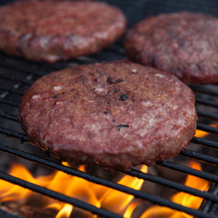 Beef or pork meat barbecue burgers for hamburger prepared grilled on bbq fire flame grill