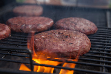 Beef or pork meat barbecue burgers for hamburger prepared grilled on bbq fire flame grill