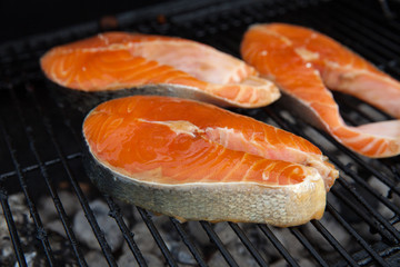 Grilled salmon red fish steaks on the flame