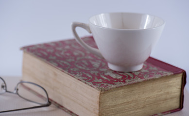 Old Hardbound Book with Spectacles and Tea Cup