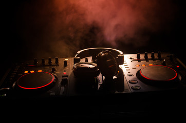 DJ Spinning, Mixing, and Scratching in a Night Club, Hands of dj tweak various track controls on...