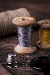 Fototapeta na wymiar Sewing instruments, threads, needles in vintaae style