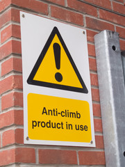 Description:
Anti vandal, anti climb paint (a non-drying tar-like paint substance) applied to the top of a metal gate with accompanying warning sign.