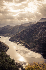 Mountains landscape in orange toned colors  around Rijeka Crnojevica river curve from high view in...