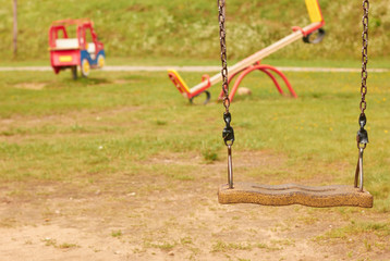 Playground in the kindergarten. Summer, sun, swings and slides