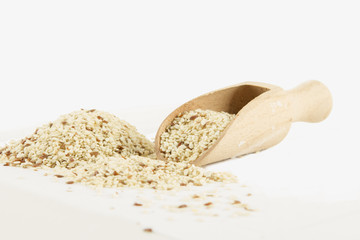 ISOLATED SESAME WITH WOODEN SPOON AND BOWL ON WHITE BACKGROUND
