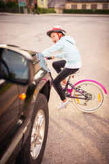Naklejka premium Accident. Girl on the bicycle crosses the road in front of a car