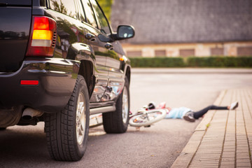 Accident. Girl on the bicycle crosses the road in front of a car